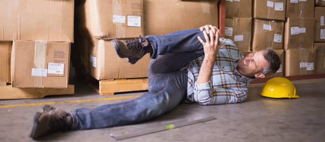 31910011 - side view of male worker lying on the floor in warehouse