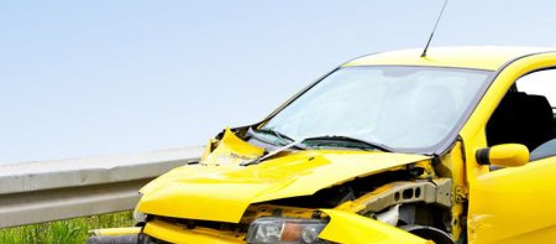 5392253 - front view of crashed yellow car at highway